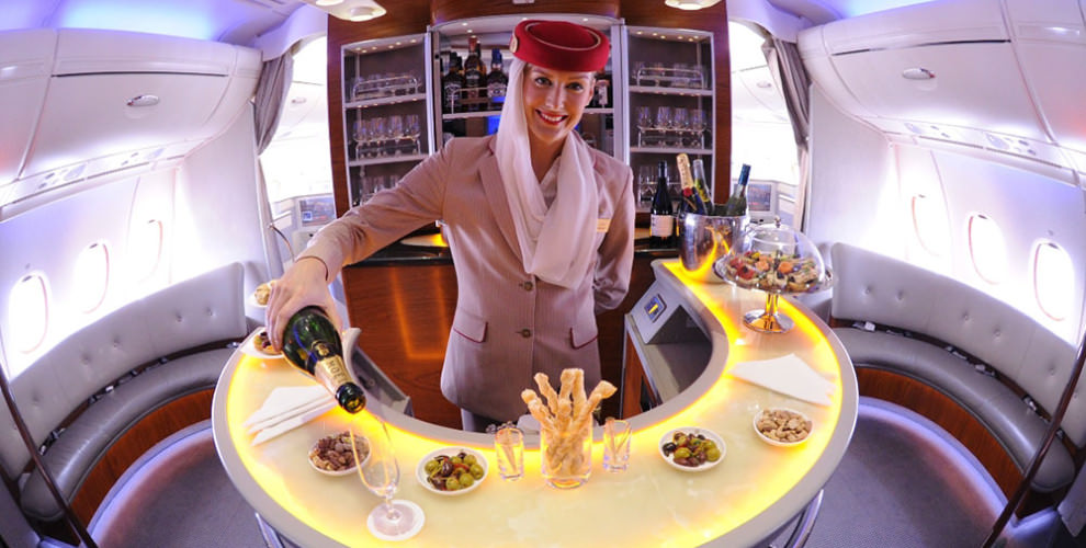 Emirates-A380-Cabin-Crew-serving-champagne-in-Onboard-Lounge-990x500