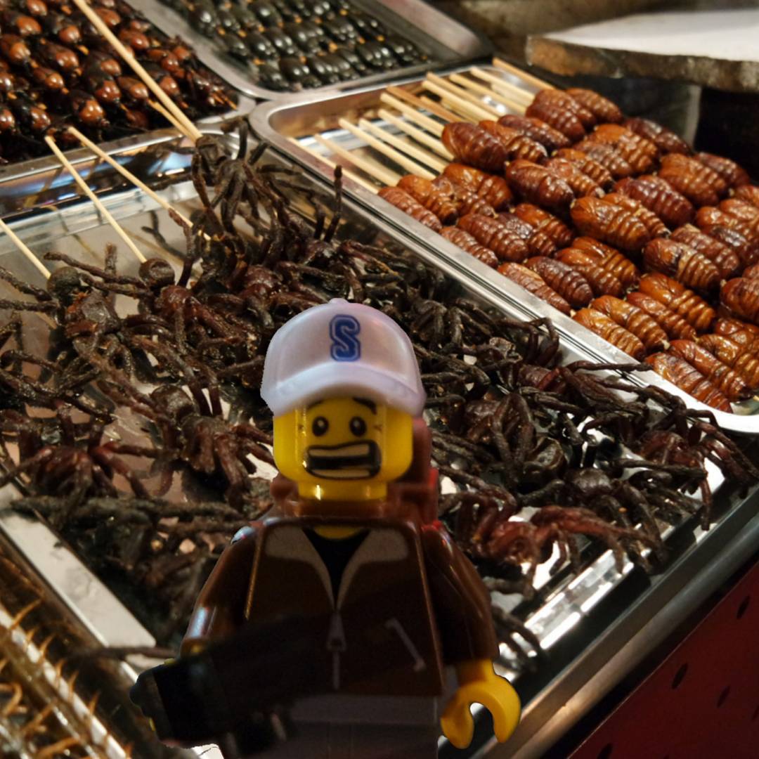 Losing his appetite at the Dong Hua Men Night Market in Beijing, China