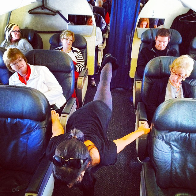 Instagram image posted by Hilaria Baldwin showing her yoga pose of the day on 1/27 "I'm sorry. You've never seen airplane pose at 35,000 feet? #yogapostureoftheday #hilariaypd thank you to all my fellow passenger yoga buddies!"