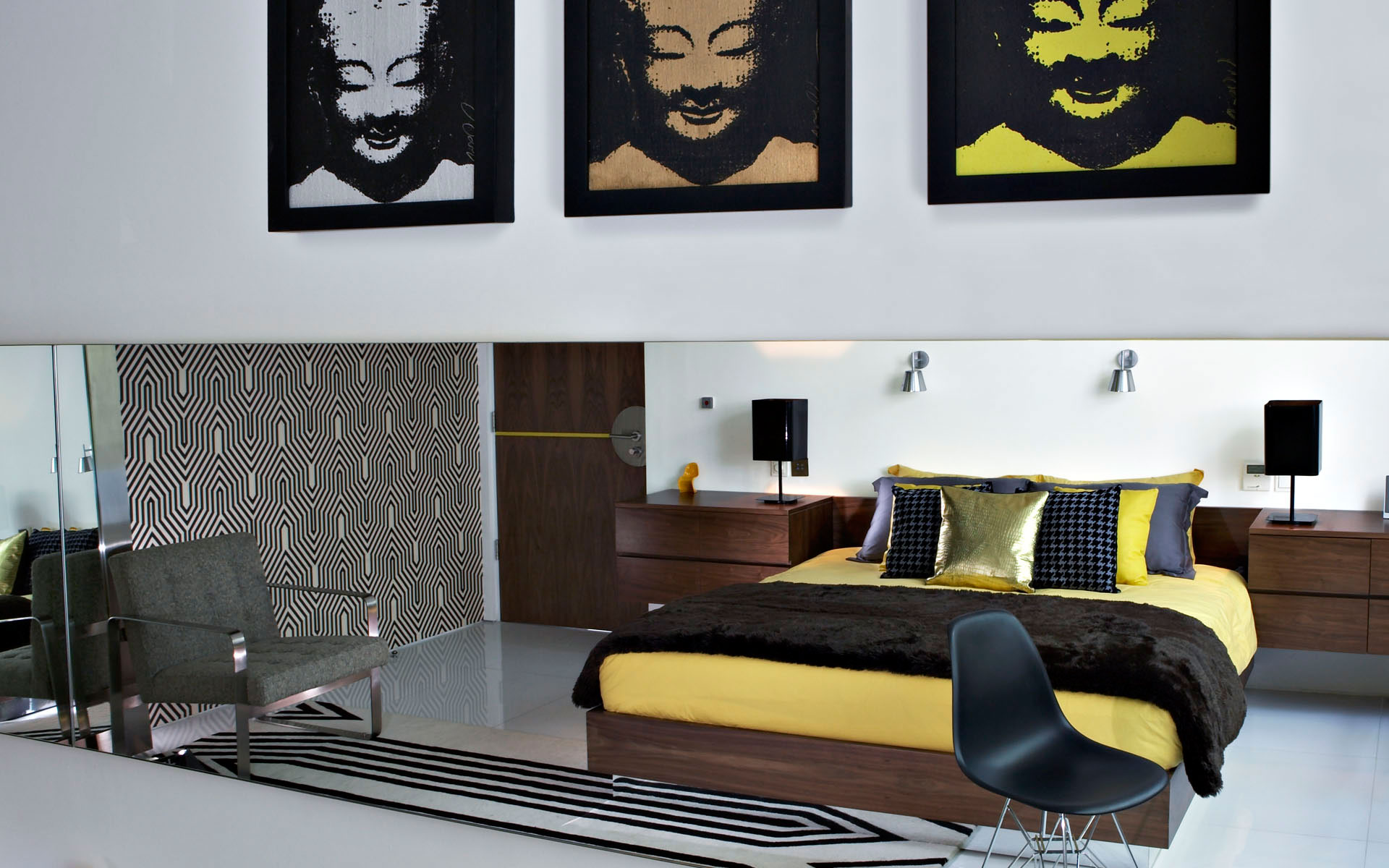 bedroom-with-wooden-bed-and-black-quilt-seen-from-long-mirror